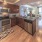 kitchen area on wooden floor with spacious counter-space and designer appliances
