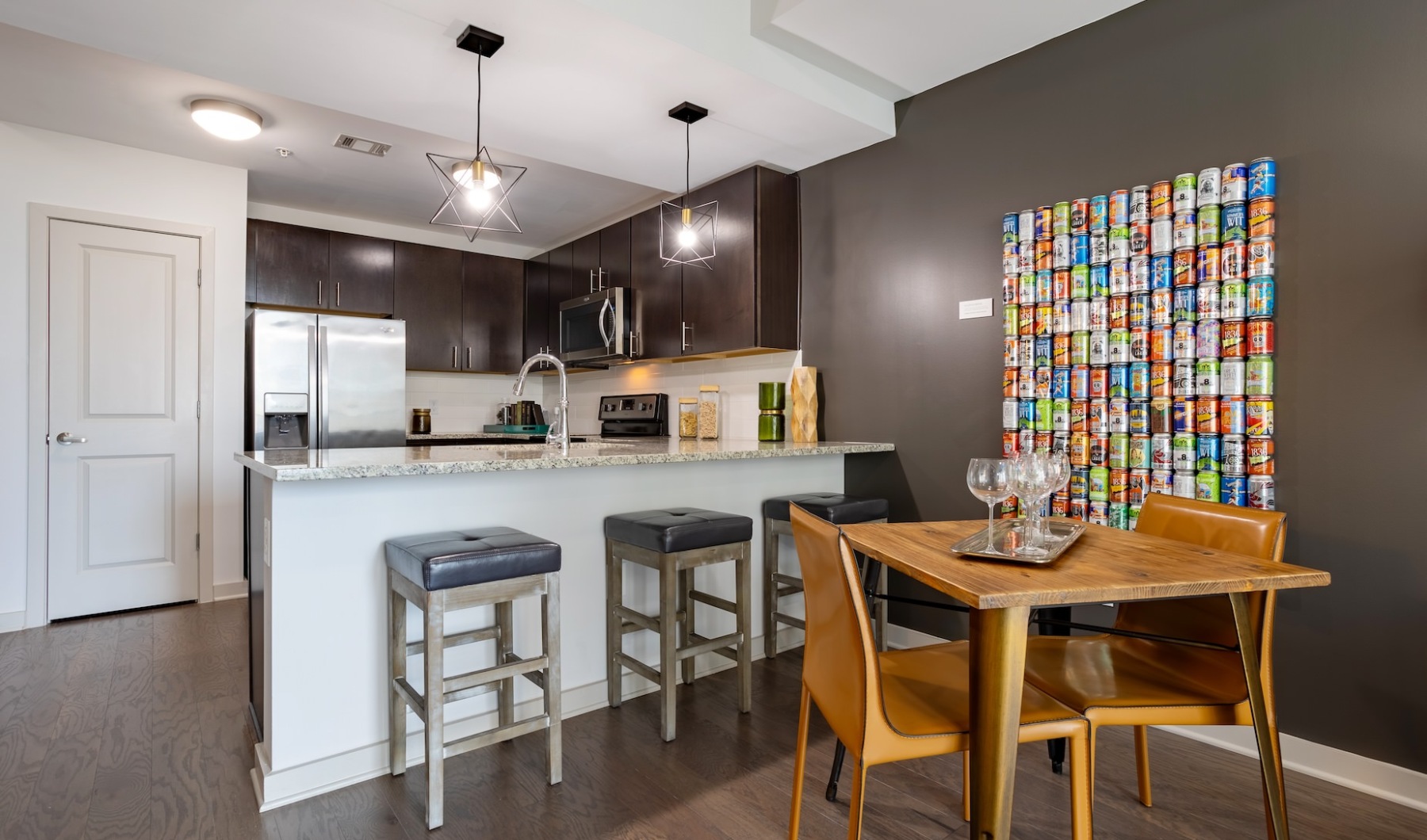 Living Begins Here rendering of living room and kitchen showing high ceilings, modern lighting and large open spaces