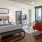 Bedroom with large bed, ensuite. queen bed and nightstands.
