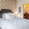 Bedroom with large bed, ensuite. queen bed and nightstands.