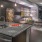 rendering of kitchen with easy access to living room in a large, well-lit room